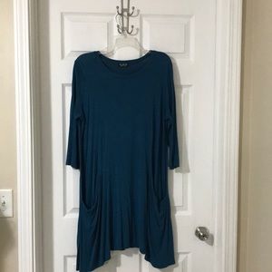 Peacock teal colored top.